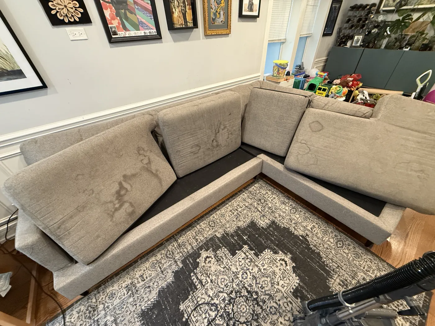 Water-stained light-gray sectional sofa before professional cleaning in Chicago
